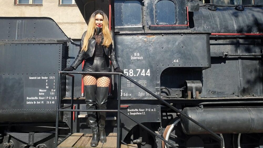 Climbing on steam locomotive, thigh high boots, leather shorts, long gloves, body